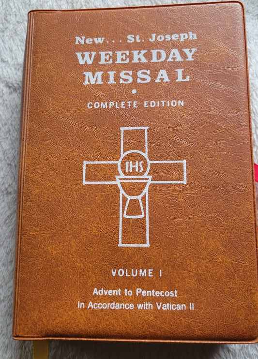 Vintage book for sale, "New....St. Joseph Weekday Missal Vol 1: Advent to Pentecost" Complete Edition, by the Catholic Book Publishing Company, "In accordance with Vatican II". View of front counter.